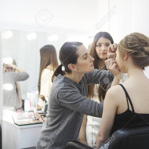 Makeup teacher with her student girl. Make up tutorial lesson at